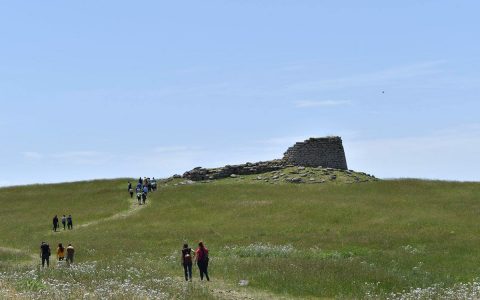 Spanish teenagers visiting the nuraghe